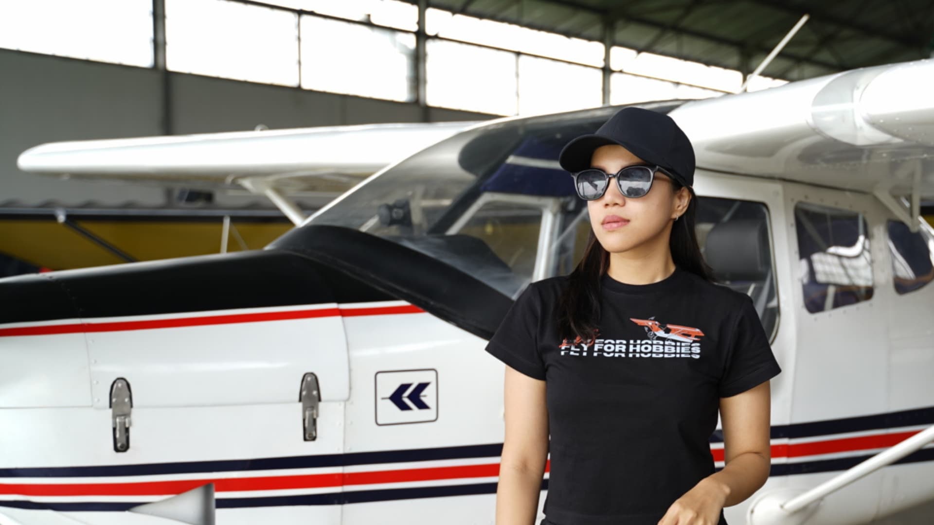 Pilot in front of a Cessna in a hangar